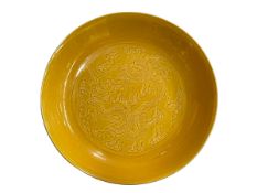 Chinese yellow glaze dish with impressed dragon design, six character mark to base, 19cm diameter.