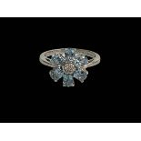 9 carat white gold petal design topaz and diamond ring, size J.