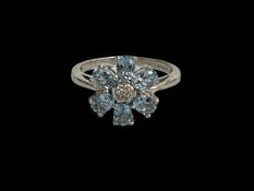 9 carat white gold petal design topaz and diamond ring, size J.