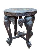Indian elephant carved circular occasional table, 61cm by 53cm diameter.