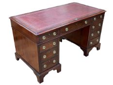 Late 19th/early 20th Century mahogany nine drawer pedestal desk, 75.5cm by 137cm by 73cm.