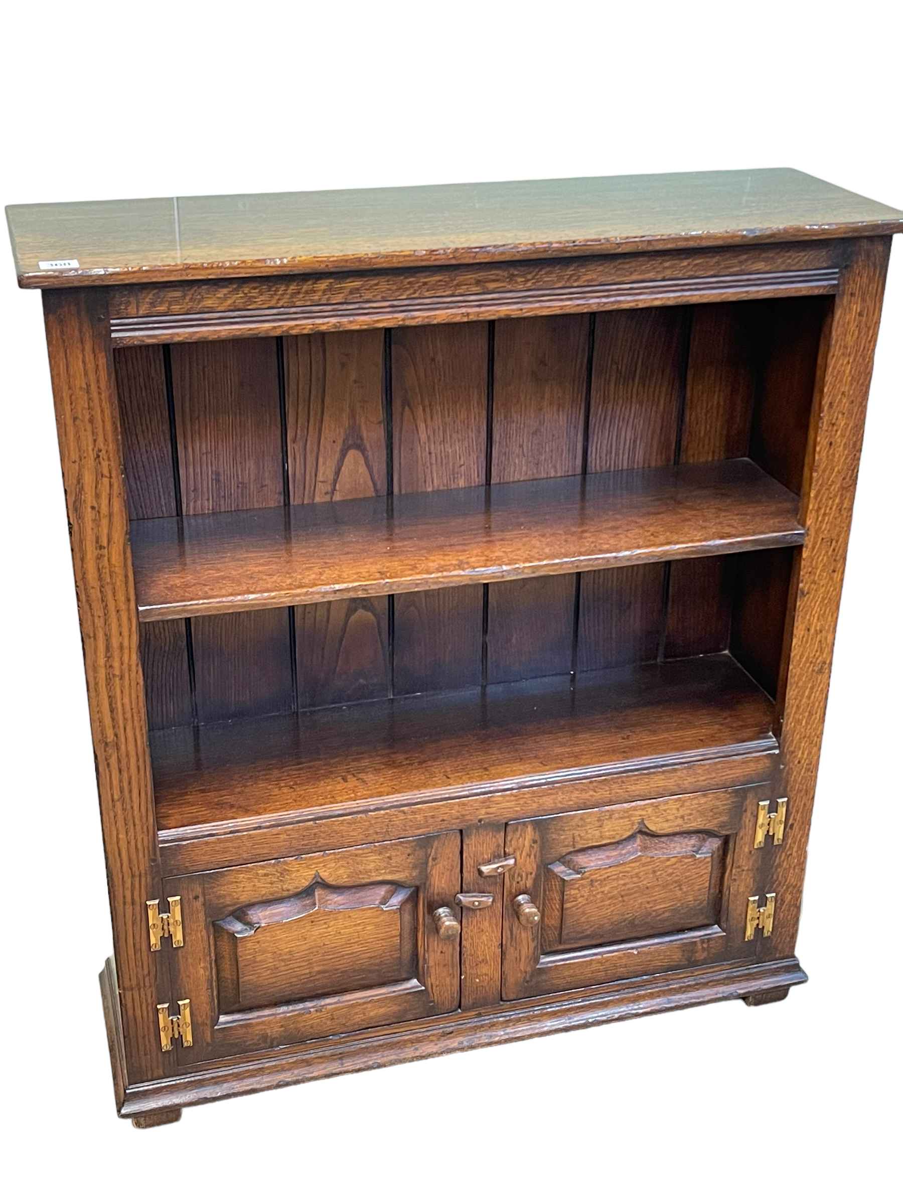 Titchmarsh & Goodwin oak cabinet bookcase having open top above two fielded panel doors,
