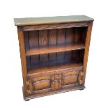 Titchmarsh & Goodwin oak cabinet bookcase having open top above two fielded panel doors,