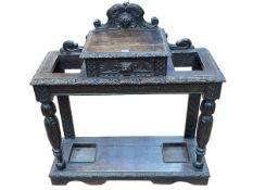 Victorian carved oak hallstand having central drawer flanked by two stick stands,