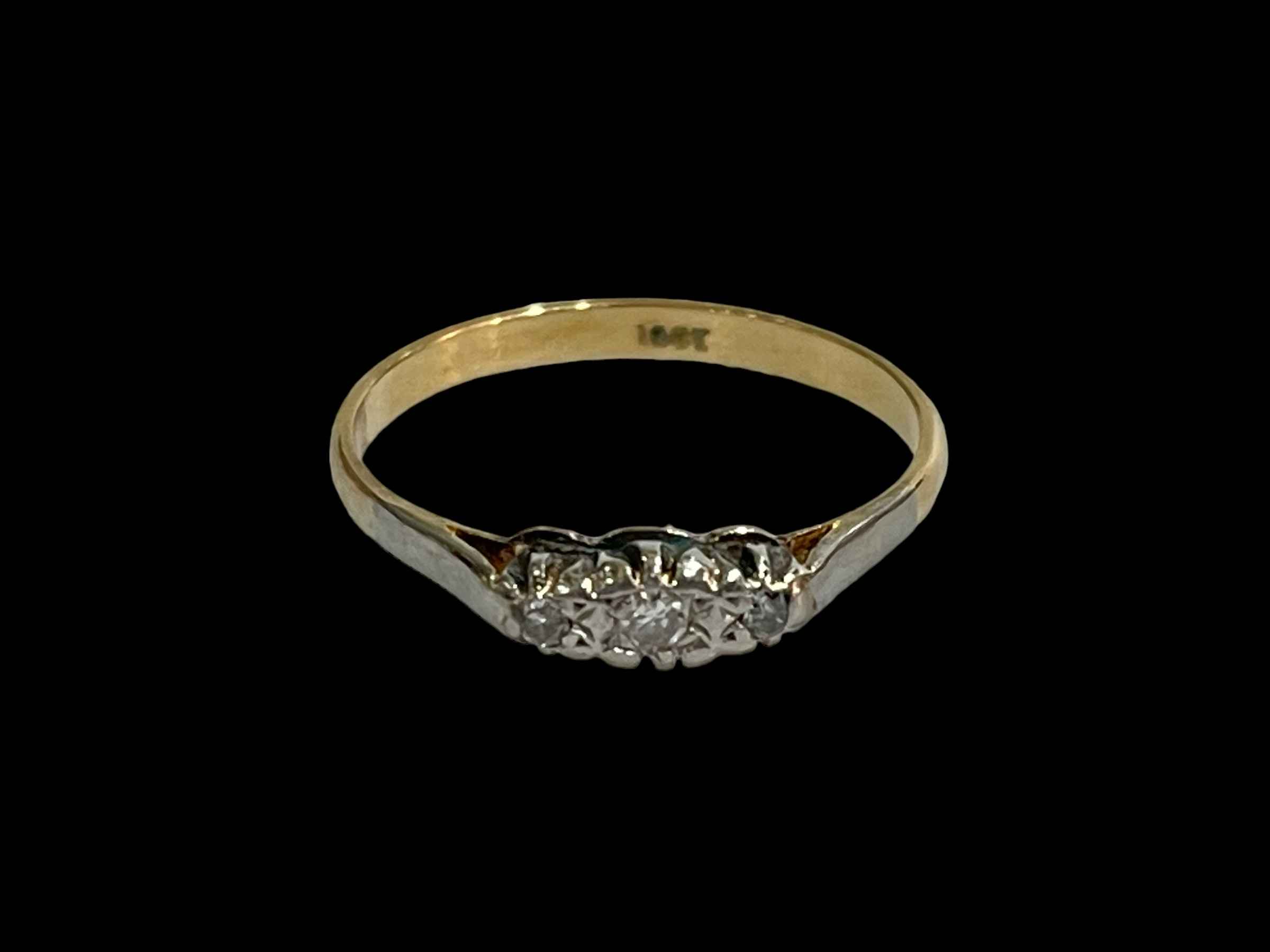 Three stone diamond 18 carat gold ring, size P.