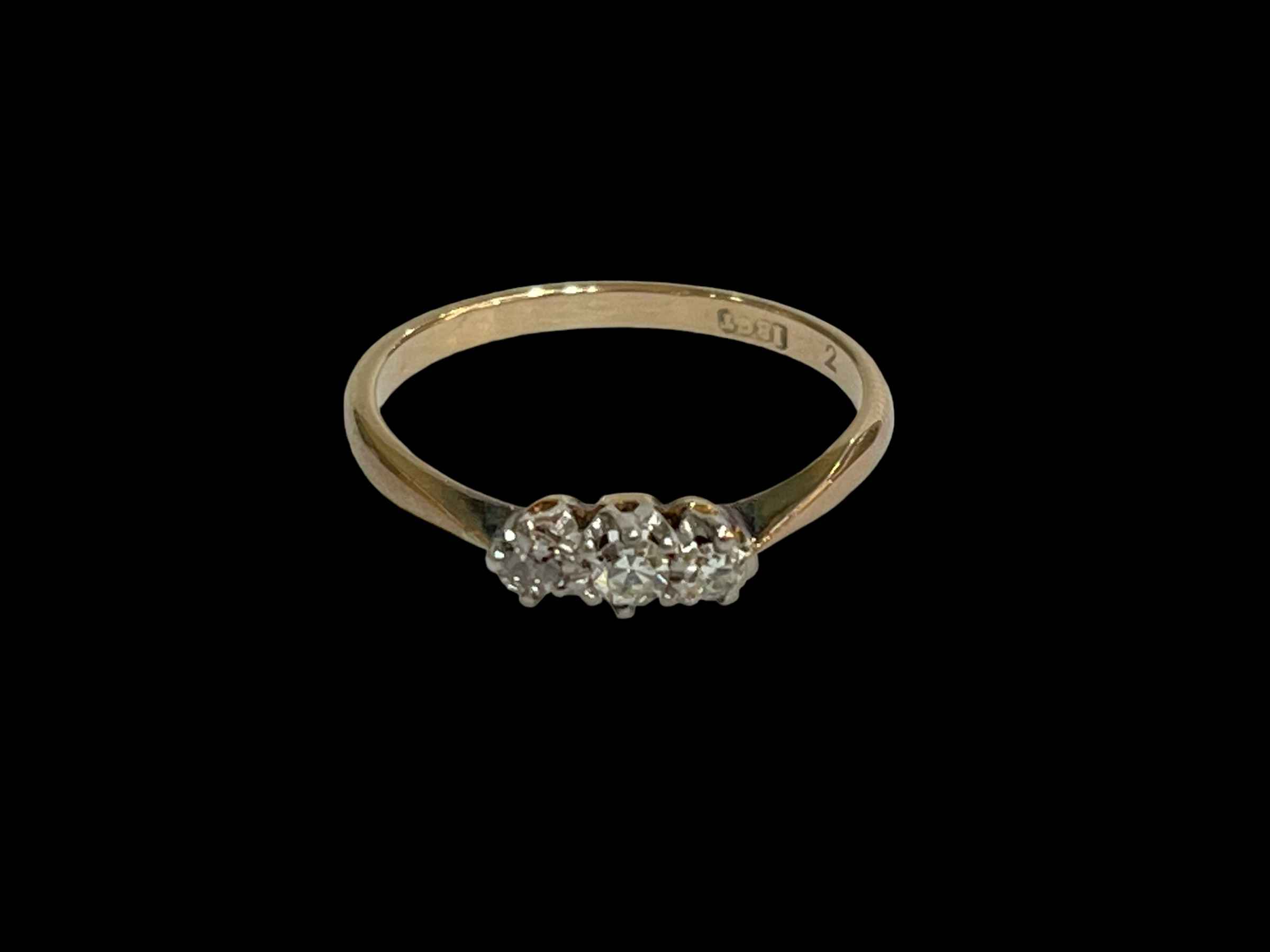 Three stone diamond 18 carat gold ring, size P.
