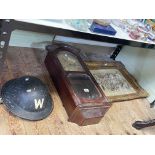 Wall clock, Warden's 'W' helmet and a framed ornate cupid wall plaque.