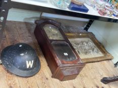 Wall clock, Warden's 'W' helmet and a framed ornate cupid wall plaque.