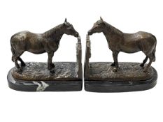 Pair of bronze horse bookends on marble bases, 17cm high.