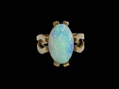 Large oval opal ring set in 14 carat yellow gold, size L.