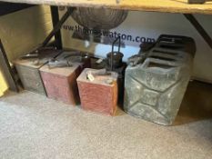 Five vintage petrol cans, two jerry cans and lamp case.