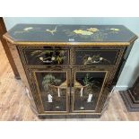 Oriental black lacquered floral and figure decorated canted corner side cabinet having two drawers