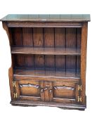 Titchmarsh & Goodwin oak cabinet bookcase having open top above two fielded panel doors,