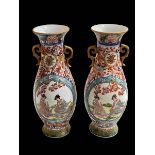 Pair of Chinese porcelain two handle vases, having panels of figure decoration, 26.5cm.