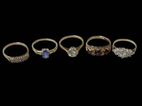 Five 9 carat gold gem set rings.