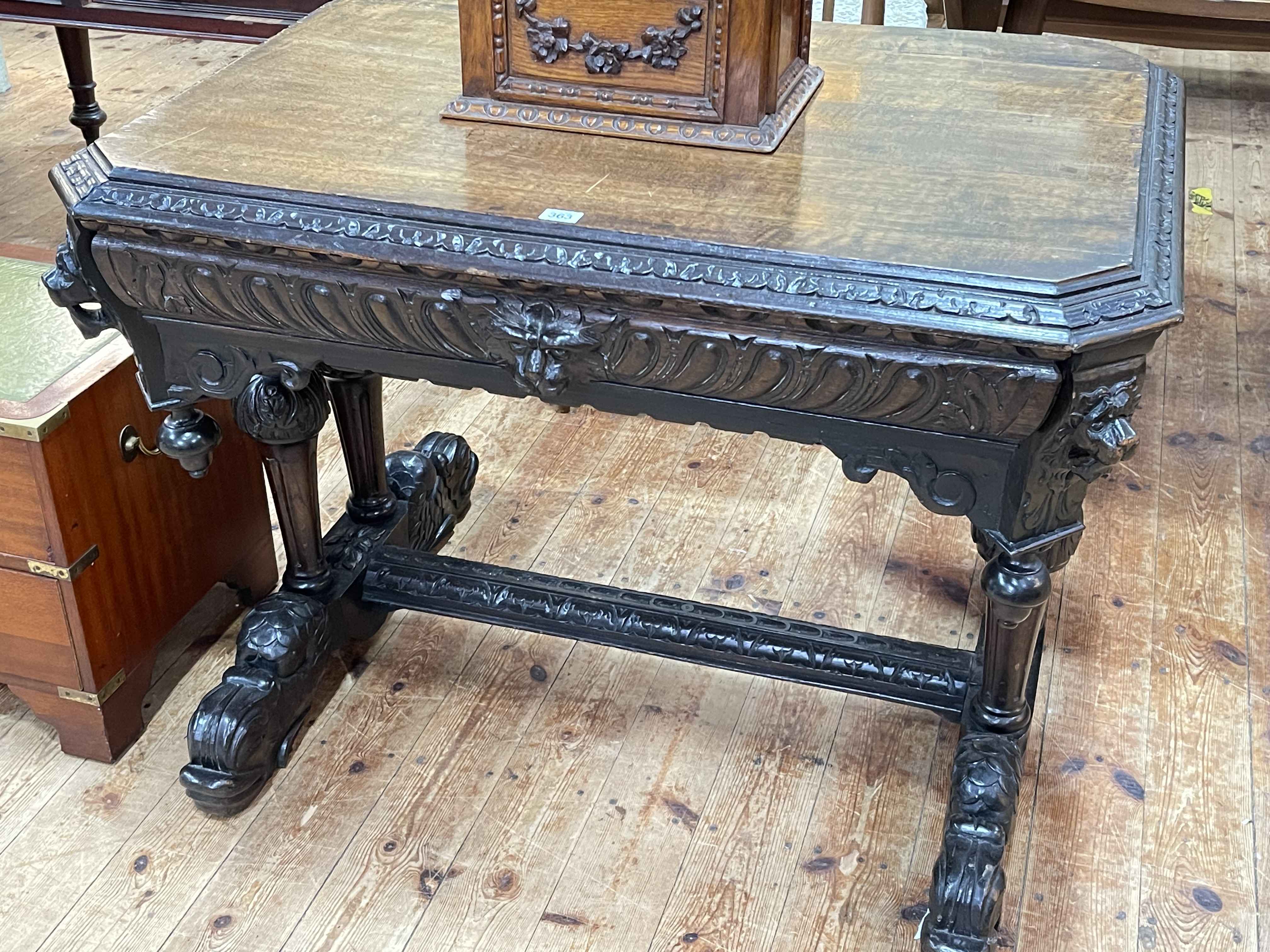Victorian carved oak canted corner centre table having frieze drawer, 73cm by 97cm by 72cm.