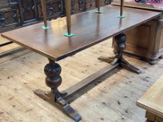 Oak refectory table raised on carved bulbous pillars, 75cm by 75cm by 165cm.