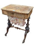 Victorian walnut sewing table having frieze drawer above a deep drawer raised on turned pillars,