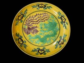 Chinese yellow glazed dish with green dragon, six character mark, 13.5cm diameter.