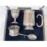 Silver christening mug, egg cup and napkin ring, boxed.