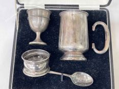 Silver christening mug, egg cup and napkin ring, boxed.