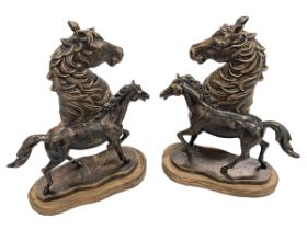 Pair of bronzed horses heads and pair of bronzed horses on wood plinths.