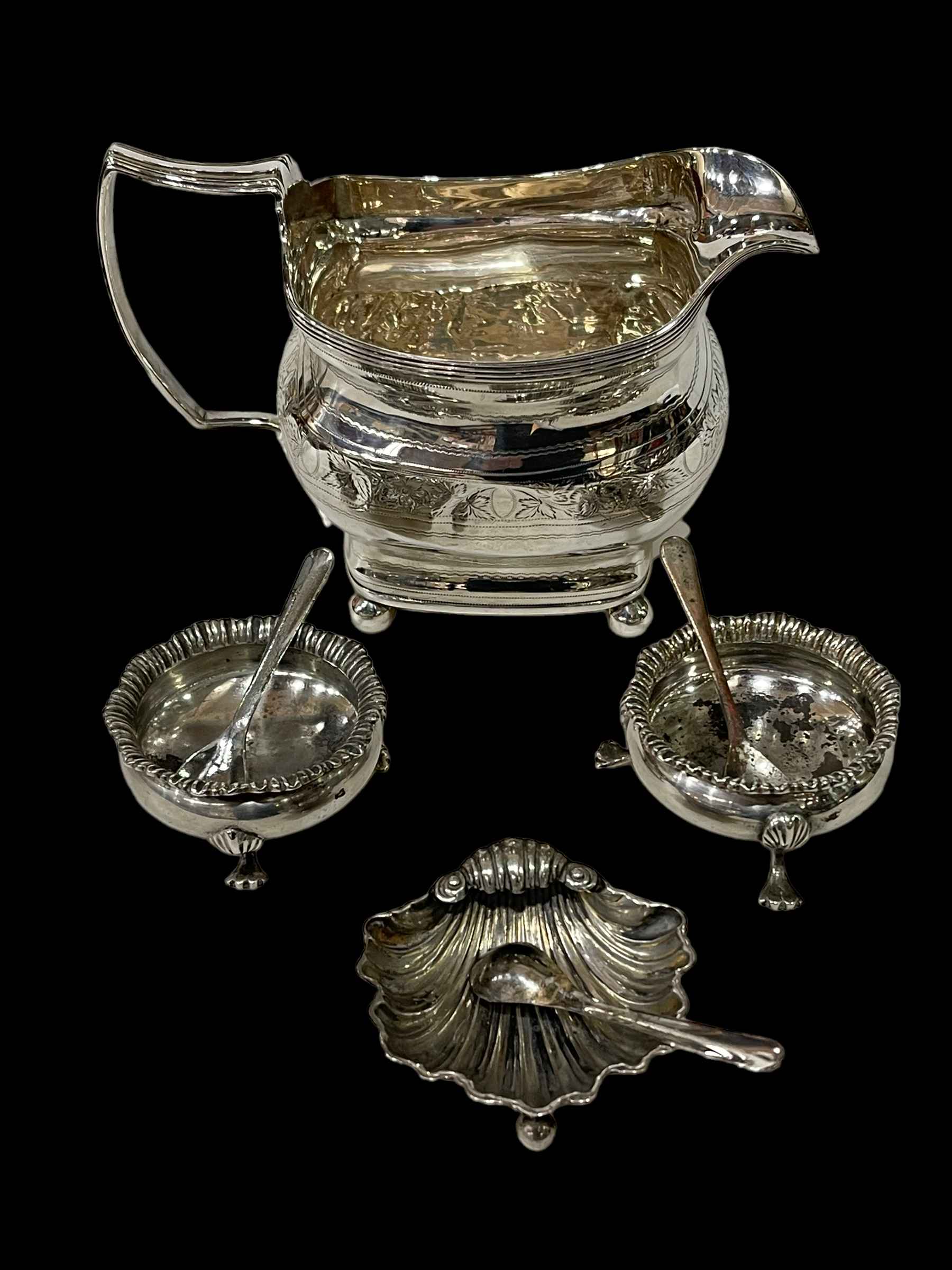Silver cream jug, pair of silver salts and shell salt with three plated salt spoons.