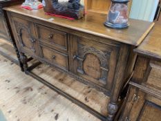 Carved oak sideboard having two central drawers flanked by two carved arched panel doors,