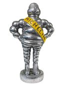 Silver coloured Michelin Man doorstop, 37cm.