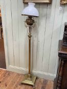 Brass corinthian column standard oil lamp on paw feet.