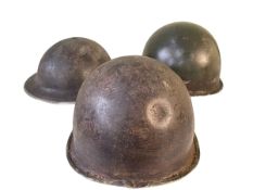 Three tin military helmets.