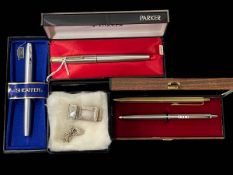 Parker, Sheaffer and Papermate pens, and silver money clip and bracelet.