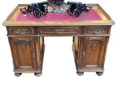 Continental carved desk having three frieze drawers above two carved panel doors enclosing six