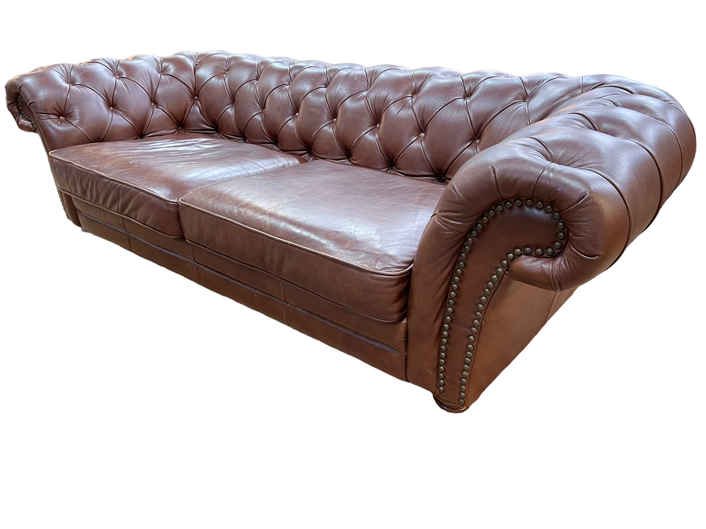 Brown buttoned leather and studded Chesterfield settee, 243cm.