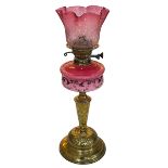 Ornate Victorian oil lamp with painted pink porcelain reservoir and a pink etched shade, 56cm high.