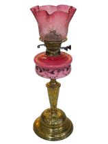 Ornate Victorian oil lamp with painted pink porcelain reservoir and a pink etched shade, 56cm high.