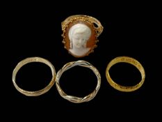 Four gold rings, one Chinese, 9 carat gold cameo and two 9 carat gold bands.