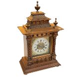 Victorian oak Gothic style mantel clock with brass and silvered dial, 56cm high.