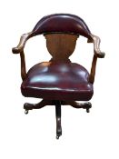 Early 20th Century oak and ox blood hide swivel office desk chair.