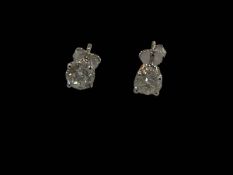 Pair diamond stud earrings set in 18 carat white gold, total diamond weight approximately 1.5 carat.