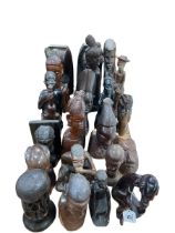 Assortment of African carved sculptures including busts.