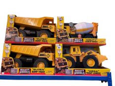 Four mighty wheels dump truck, cement mixer and front loader.