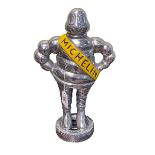 Silver coloured Michelin Man doorstop, 37cm.