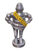 Silver coloured Michelin Man doorstop, 37cm.