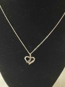 9k white gold heart pendant and chain set with sapphires and diamonds.