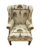 Georgian style wing armchair in gold arboreal pattern fabric.