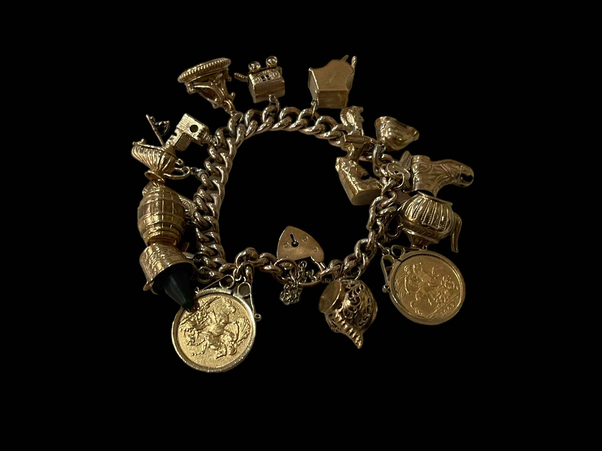 9 carat gold charm bracelet with two gold sovereigns 1907 and 1912, and seventeen charms.