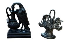 Two cast metal door stops, 28cm and 25cm high.