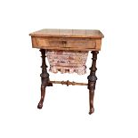 Victorian walnut sewing table having frieze drawer above a deep drawer raised on turned pillars,