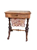 Victorian walnut sewing table having frieze drawer above a deep drawer raised on turned pillars,